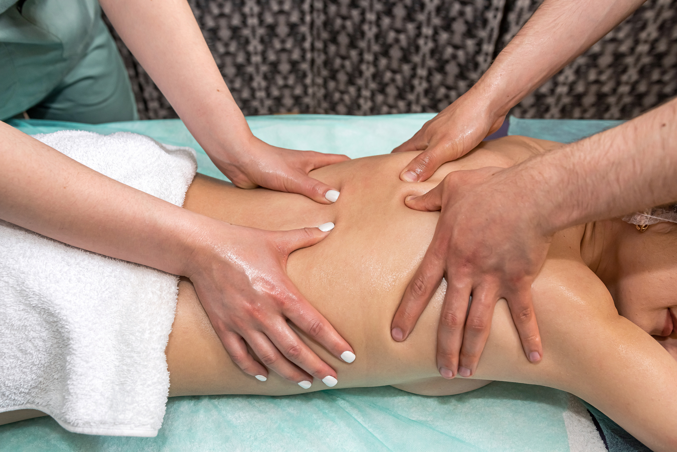Wellness Massage in the Spa Salon Is Performed by Specialists in Four Hands.